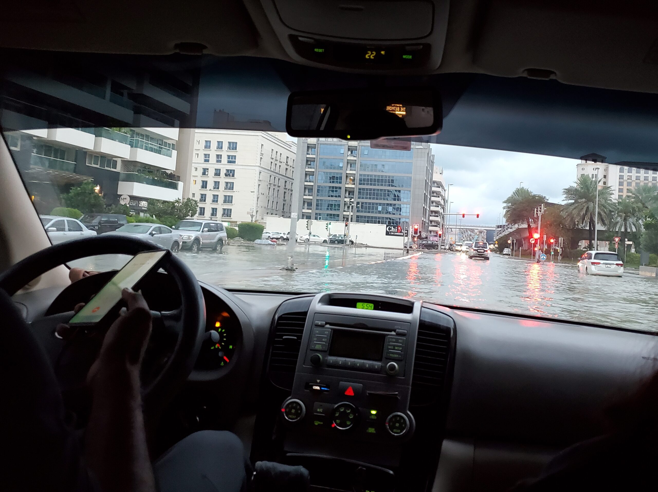 View of the flooded street at Dubai viewed from the backseat of a car through the windshield 